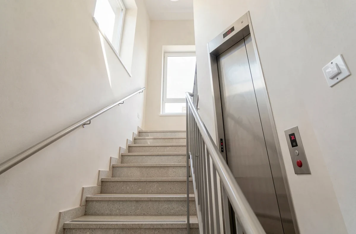 Cage d'escalier d'un petit immeuble avec gaine d'ascenseur